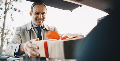Man being given a large gift